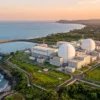Aerial view of an Indian coastal nuclear power station at sunset, illustrating the nuclear energy CO2 emissions avoided in India