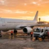 Commercial aircraft being refuelled on an airport tarmac at sunrise, representing India's sustainable aviation fuel and CORSIA mandate