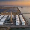 e-methanol plant Kandla: green shipping fuel production facility with electrolysers, storage tanks and solar and wind power at an Indian seaport